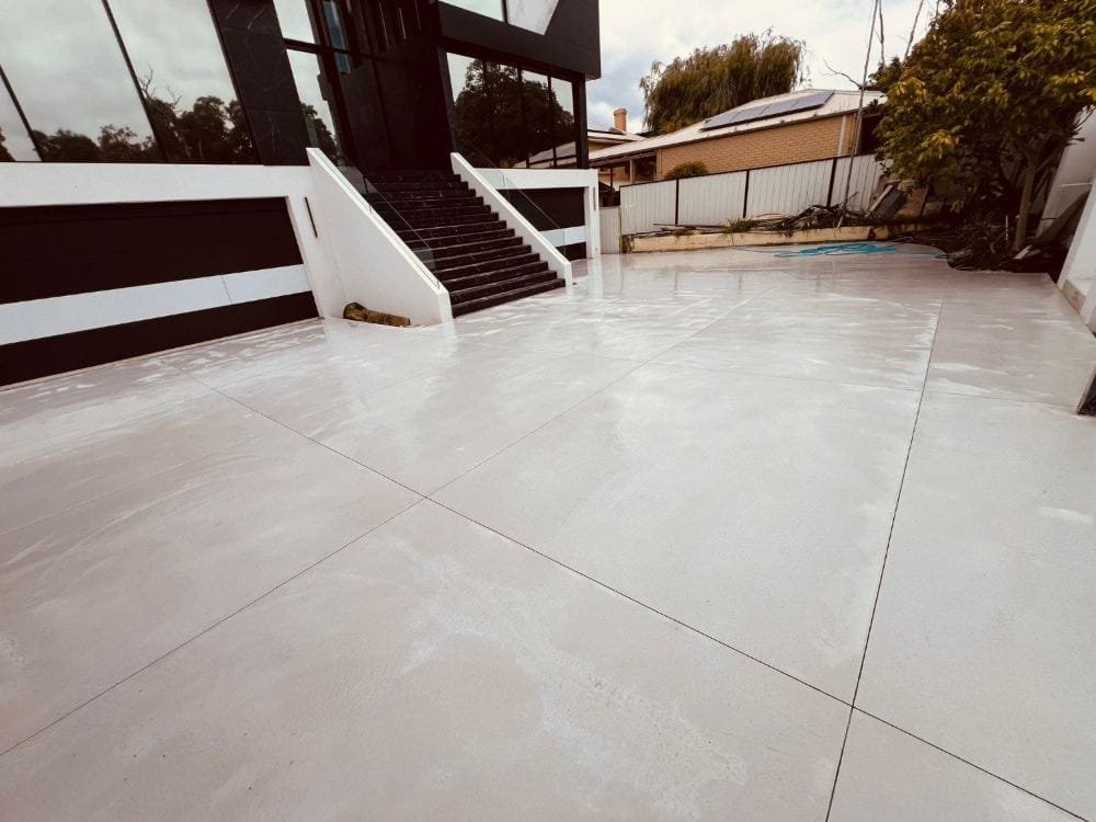 Modern architectural home with a premium honed concrete courtyard by SID & Jazz