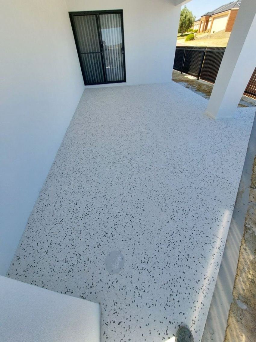 White honed-concrete alfresco under a modern portico
