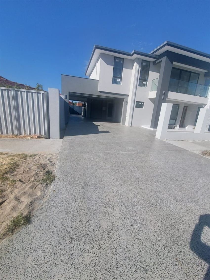 Exposed aggregate driveway at a modern two-storey home