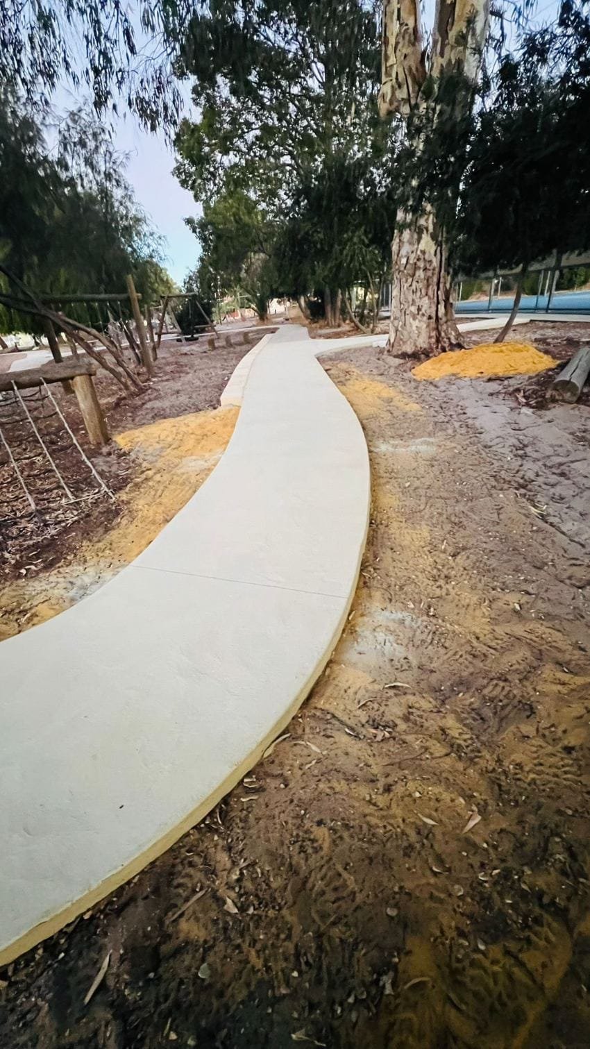 Decorative curved concrete path winding through a park