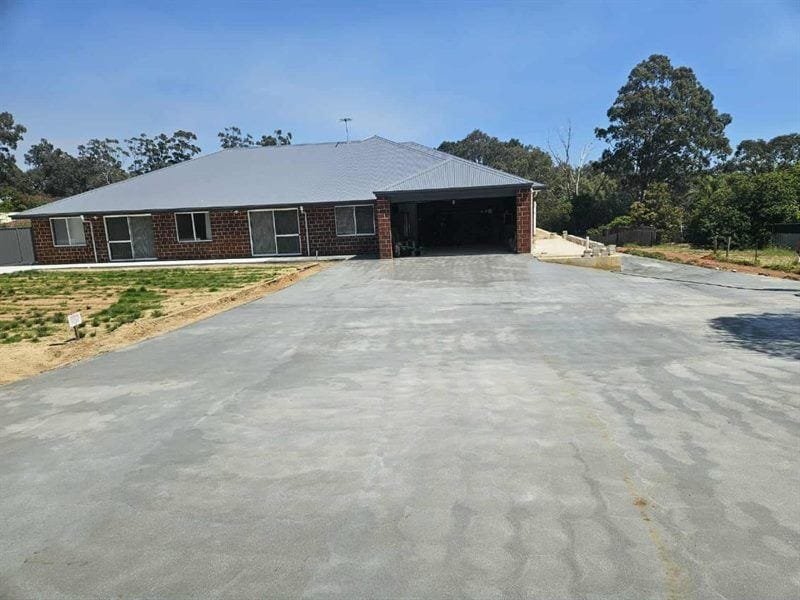 Finished home with a fresh concrete driveway
